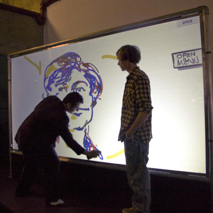 Painting on a digital graffiti wall at the LOAD Exhibition, Royal Albert Hall, London, UK.